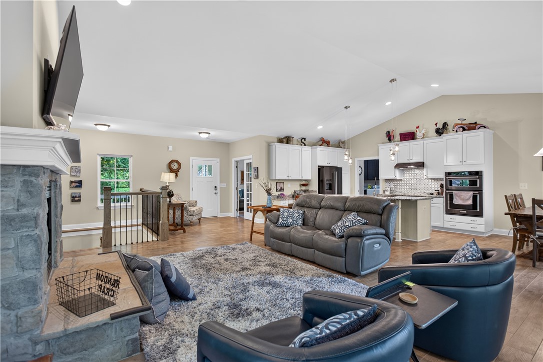321 High Hampton Road Salem, SC 29676 - Photo 6 of 46 Vaulted ceilings and warm wood floors enhance this spacious, open-concept living area with stone fireplace.