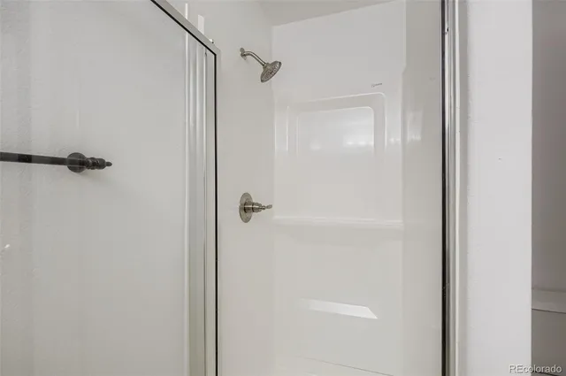 a bathroom with a glass shower door