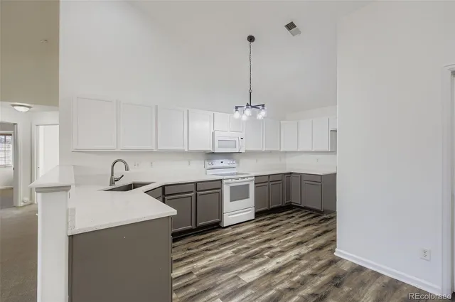 a kitchen with kitchen island granite countertop a sink stainless steel appliances and cabinets