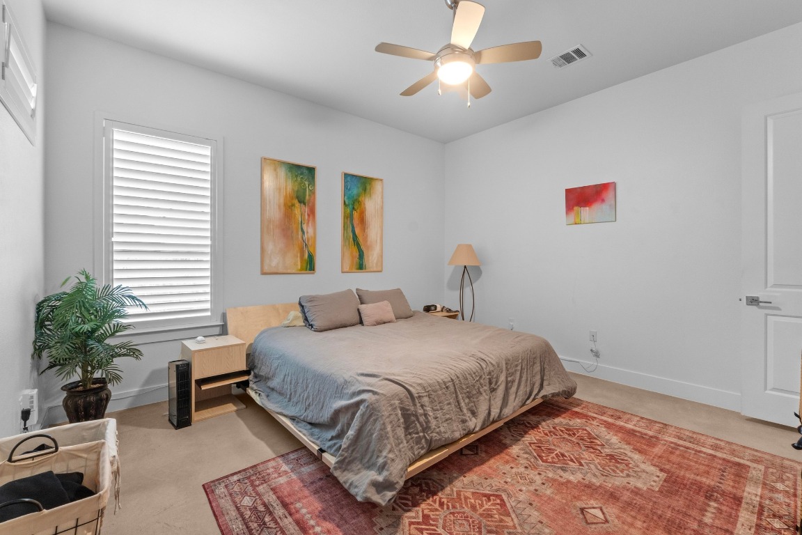 4801 Louis Avenue, Unit 1 Austin, TX 78721 - Photo 16 of 26 Bedroom featuring baseboards and a ceiling fan