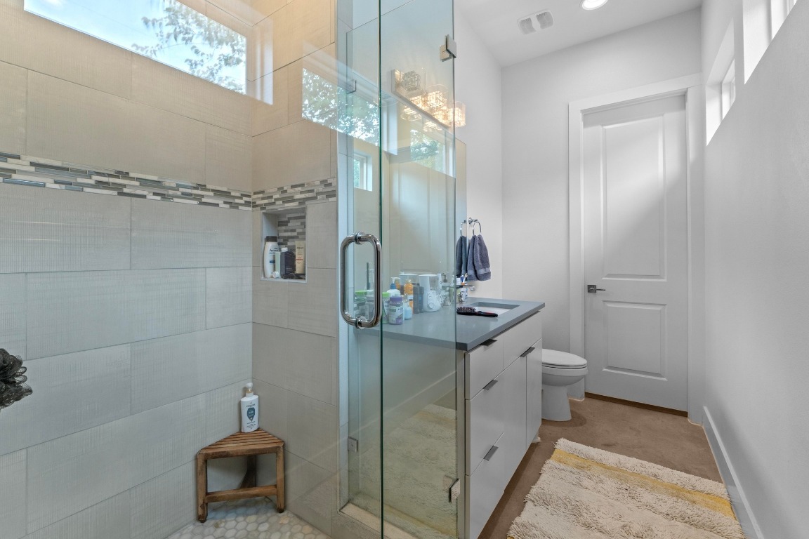4801 Louis Avenue, Unit 1 Austin, TX 78721 - Photo 17 of 26 Bathroom featuring vanity and a shower stall