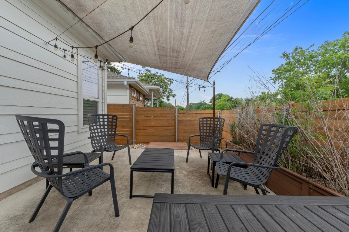 4801 Louis Avenue, Unit 1 Austin, TX 78721 - Photo 25 of 26 Wooden deck with a fenced backyard and a patio area