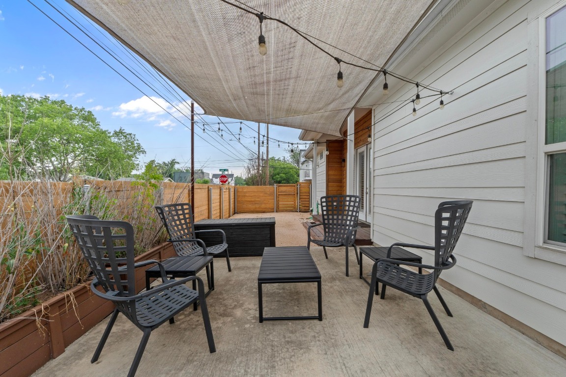 4801 Louis Avenue, Unit 1 Austin, TX 78721 - Photo 26 of 26 Fenced backyard with a patio area and outdoor lounge area