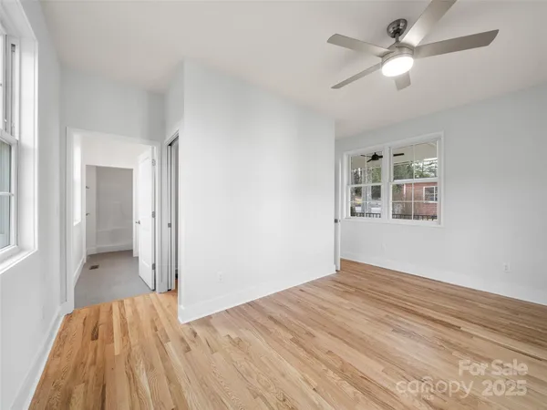 a view of empty room with wooden floor