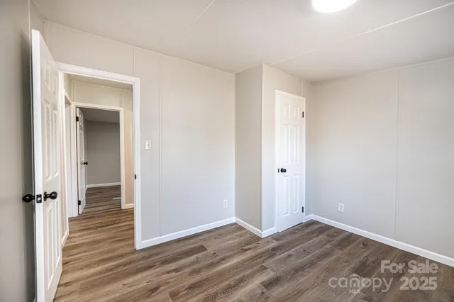 a view of a room with wooden floor