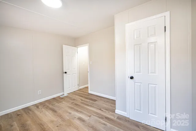 a view of a room with wooden floor and closet