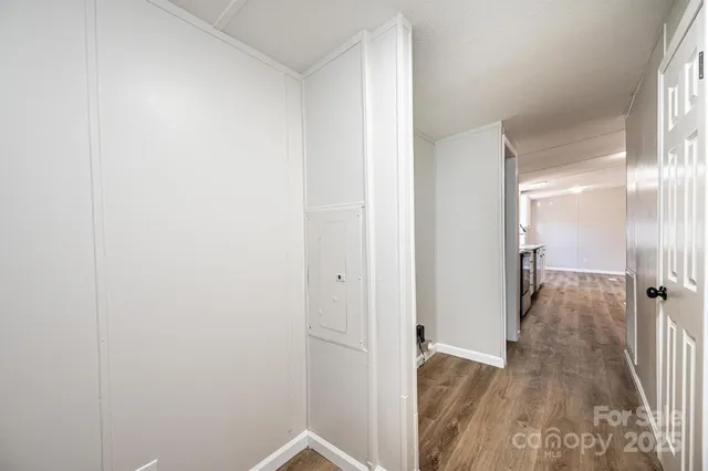a view of a room with wooden floor