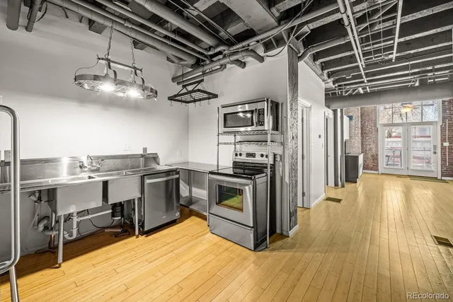 a kitchen with stainless steel appliances granite countertop a stove and a refrigerator