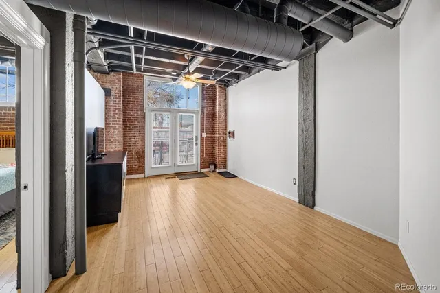 a view of empty room with wooden floor