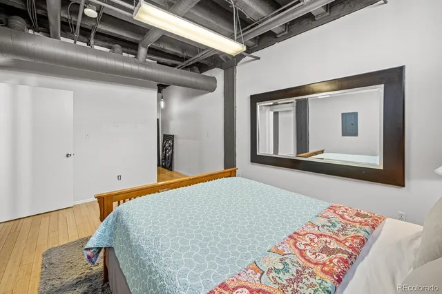 a bedroom with a bed and a mirror