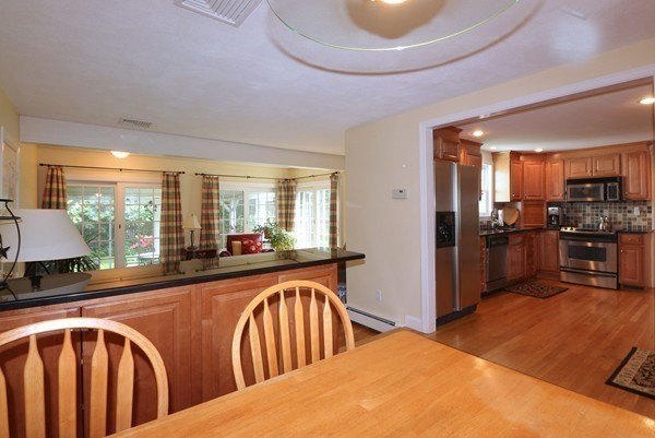 43 Boulder Brook Road Wellesley, MA 02481 - Photo 7 of 23 a kitchen with stainless steel appliances granite countertop a refrigerator a sink a stove and island
