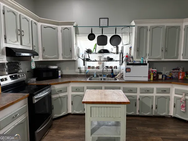 a kitchen with stainless steel appliances granite countertop a stove and cabinets