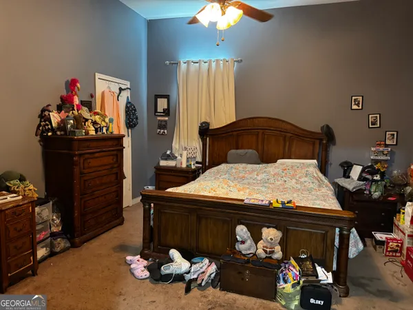 a bed sitting in a room next to a window
