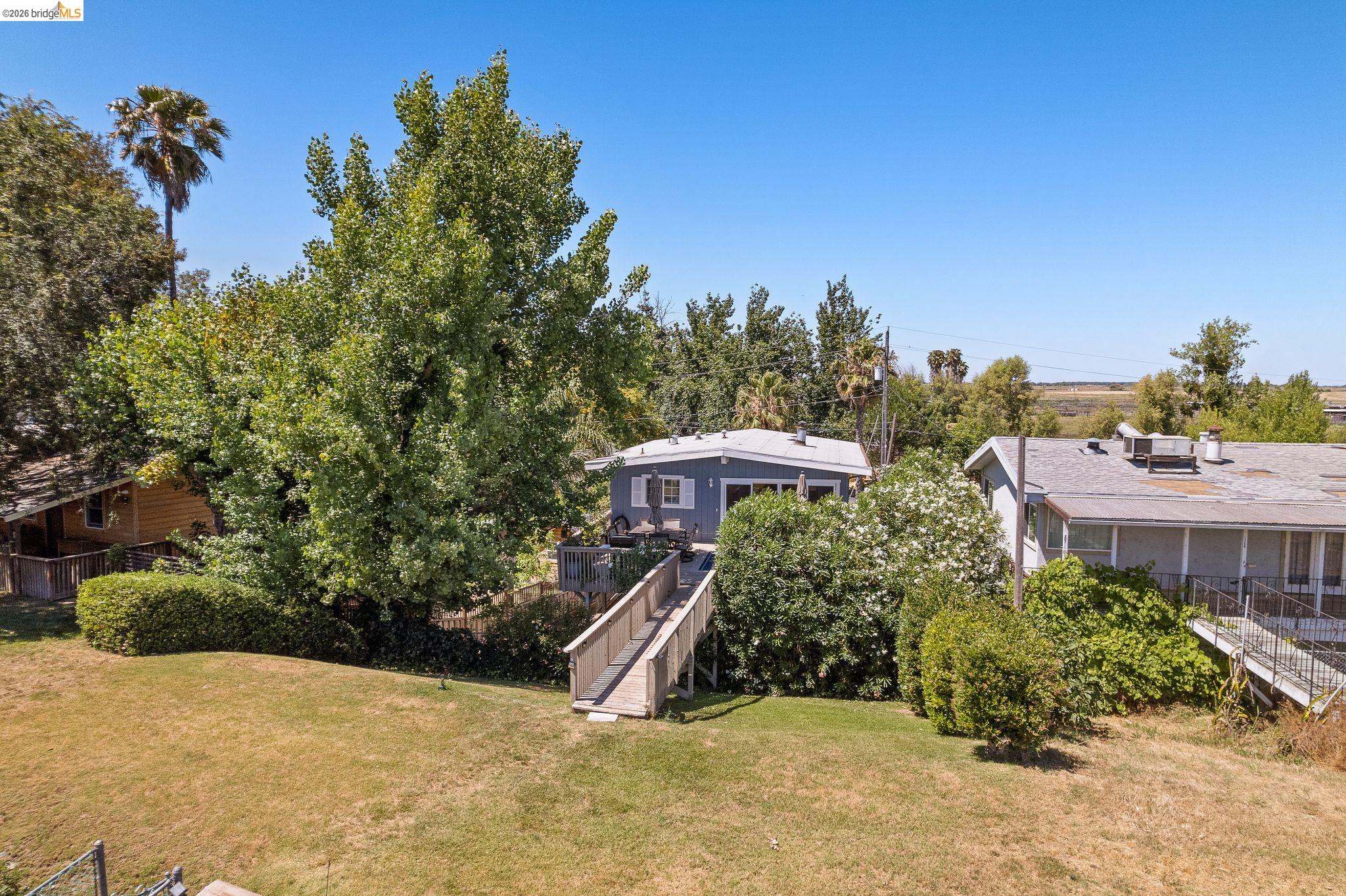 1704 Taylor Road Bethel Island, CA 94511 - Photo 62 of 73 Elevated property featuring a light blue exterior, a spacious deck, and a long wooden walkway