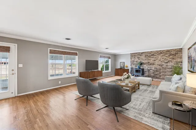 a view of a big house with a big yard and large trees