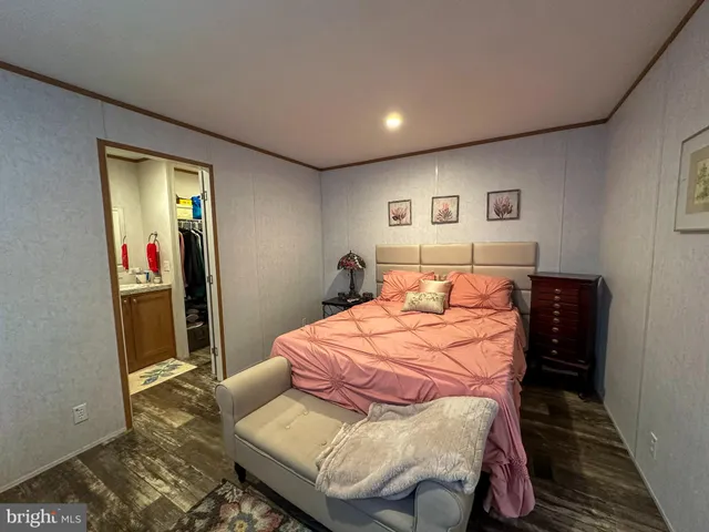 a bedroom with a bed and a mirror