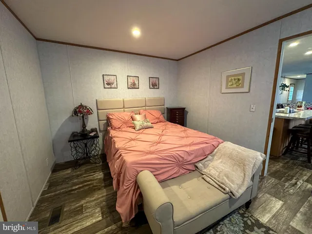a bedroom with a bed and a lamp on table