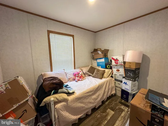 a bedroom with a bed and a tv