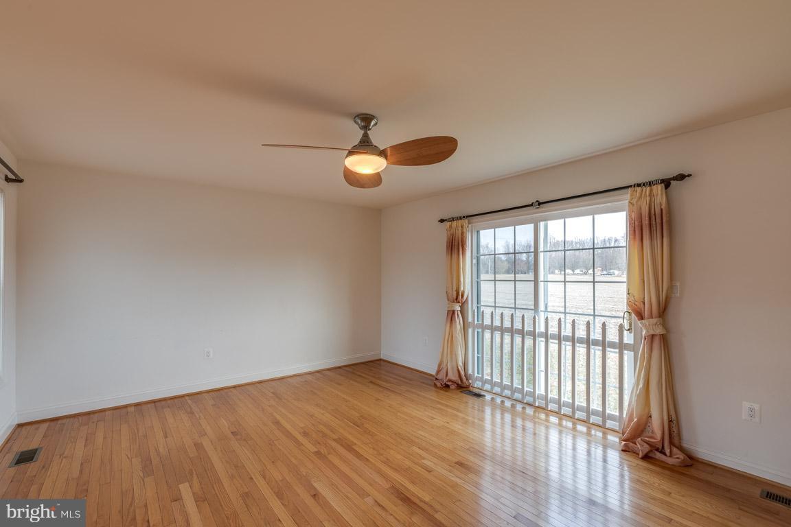 97 Swaggers Point Road Solomons, MD 20688 - Photo 13 of 28 a view of an empty room with wooden floor and a window