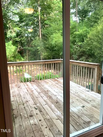 a kitchen with a refrigerator and wooden floor