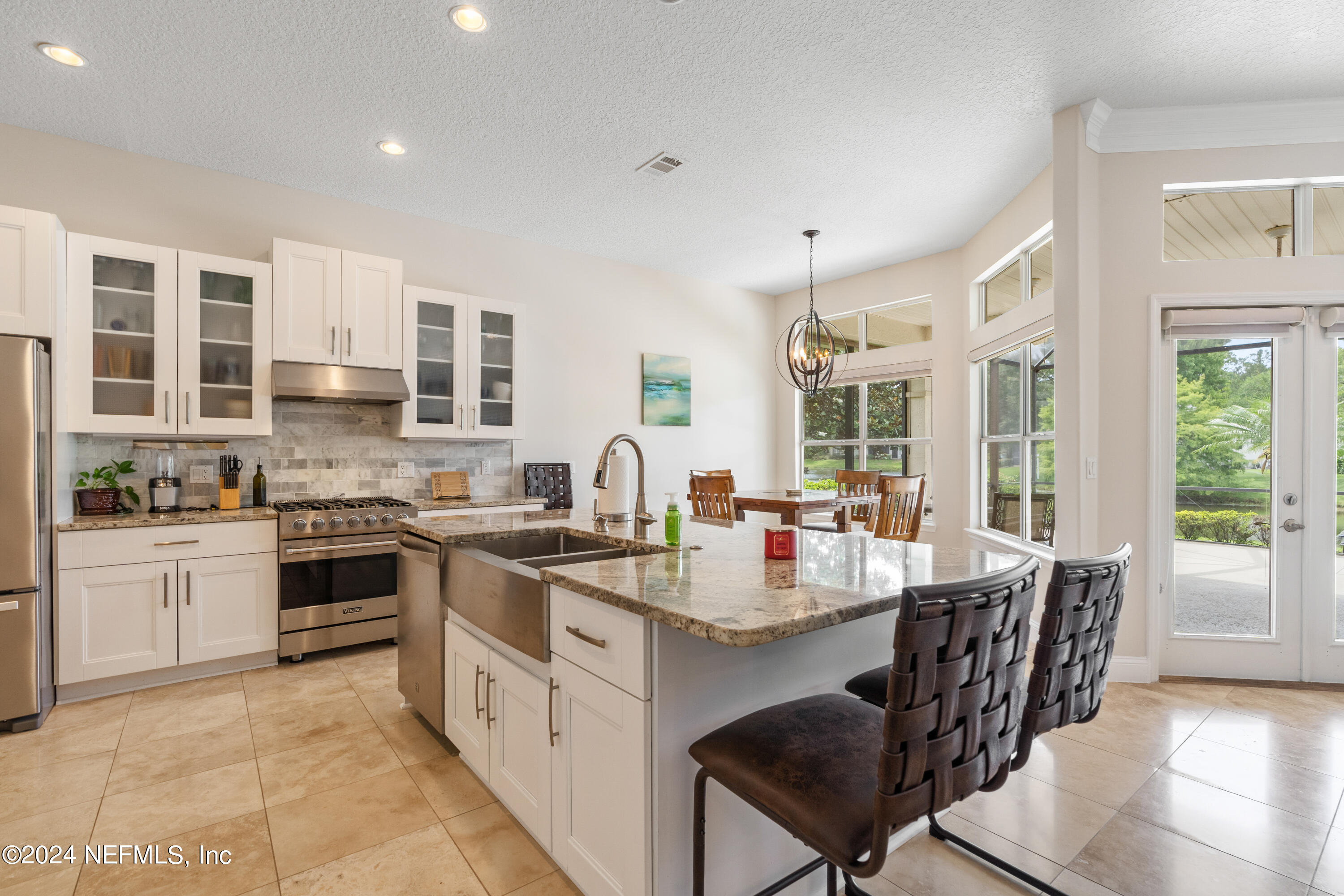 1144 Sandlake Road St. Augustine, FL 32092 - Photo 5 of 15 a large kitchen with stainless steel appliances granite countertop a stove and a sink