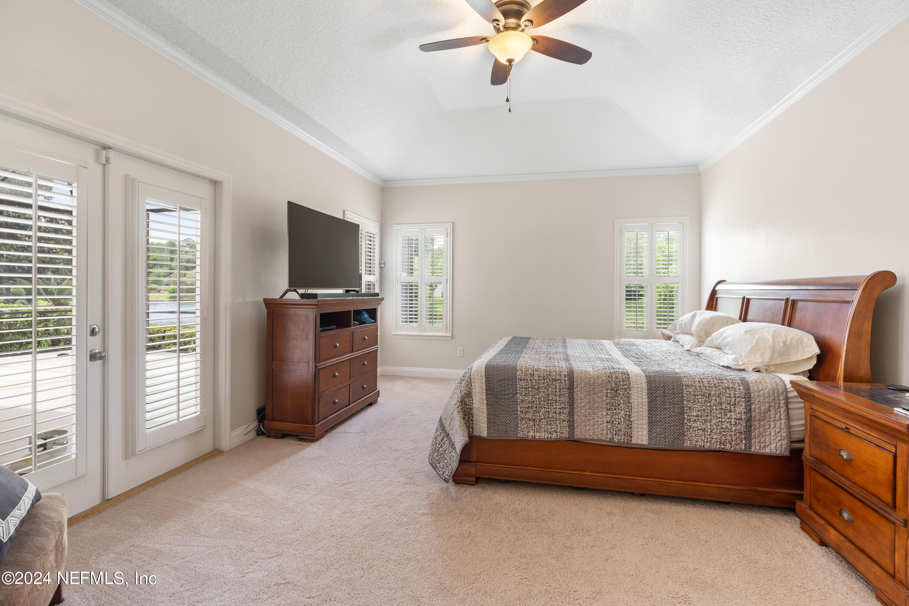 1144 Sandlake Road St. Augustine, FL 32092 - Photo 6 of 15 a bedroom with a bed and a chandelier