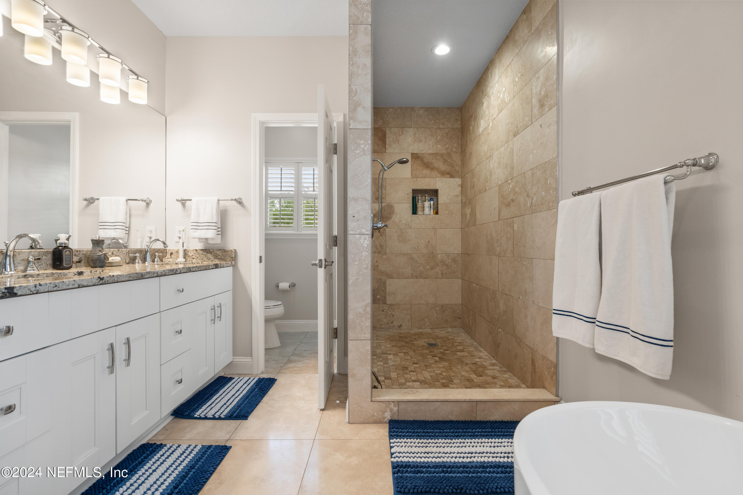 1144 Sandlake Road St. Augustine, FL 32092 - Photo 9 of 15 a bathroom with a granite countertop sink a toilet and shower