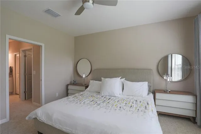 a bedroom with a bed and a painting on the wall