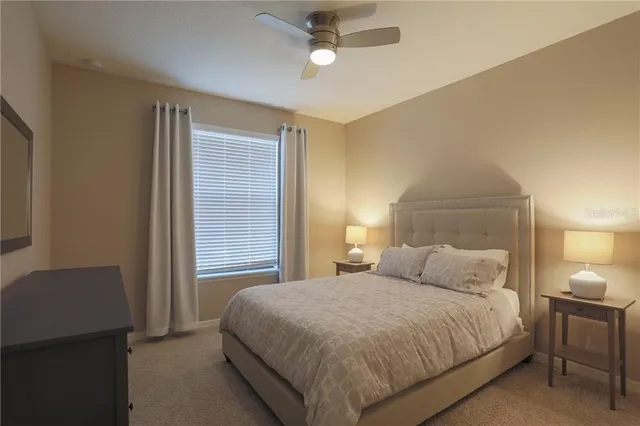 a bedroom with a bed and a lamp with window