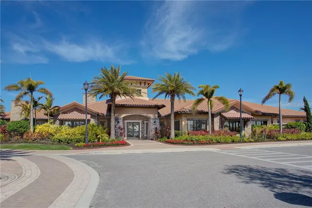 a view of multiple houses with a yard and potted plants