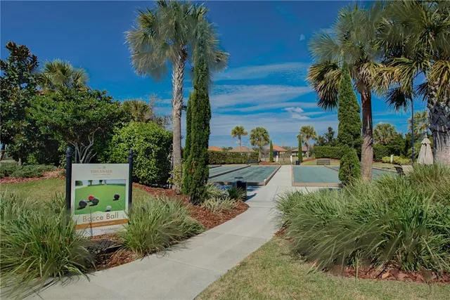 a view of a lake with couches chairs under an umbrella