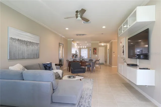 a living room with furniture and a large mirror