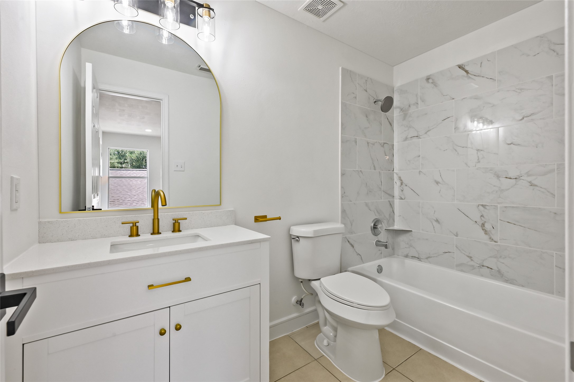 23311 Leafstone Lane Spring, TX 77373 - Photo 22 of 35 Secondary bathroom featuring a sleek vanity, modern fixtures, and a stylish tub with marble tile accents.