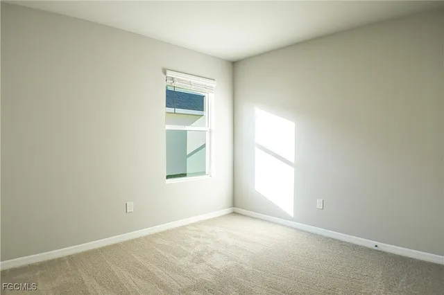 a view of an empty room and a window