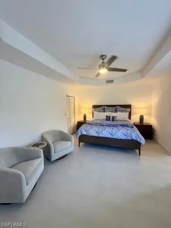 a living room with furniture and a ceiling fan