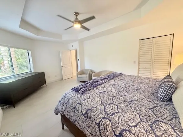 a bedroom with a large bed and a window