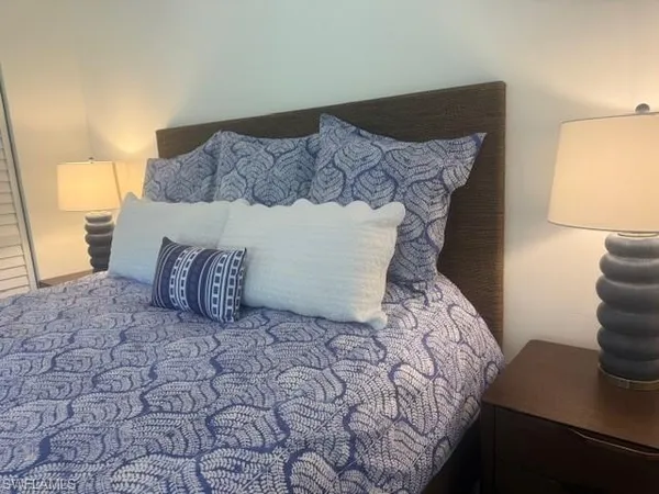 a bed sitting in a bedroom and chair