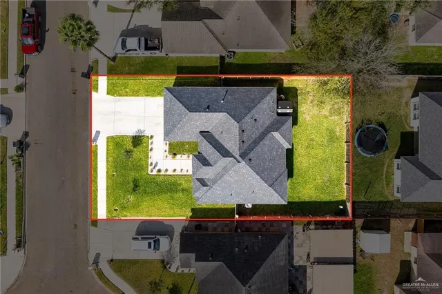 an aerial view of a house with a swimming pool