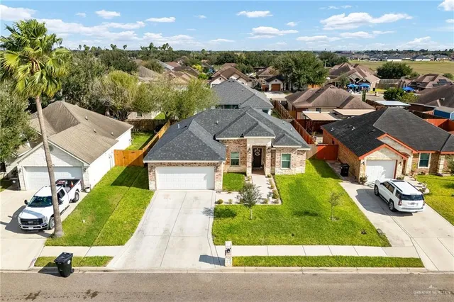 an aerial view of a house with a garden and plants