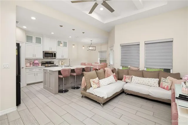 a living room with furniture and kitchen view