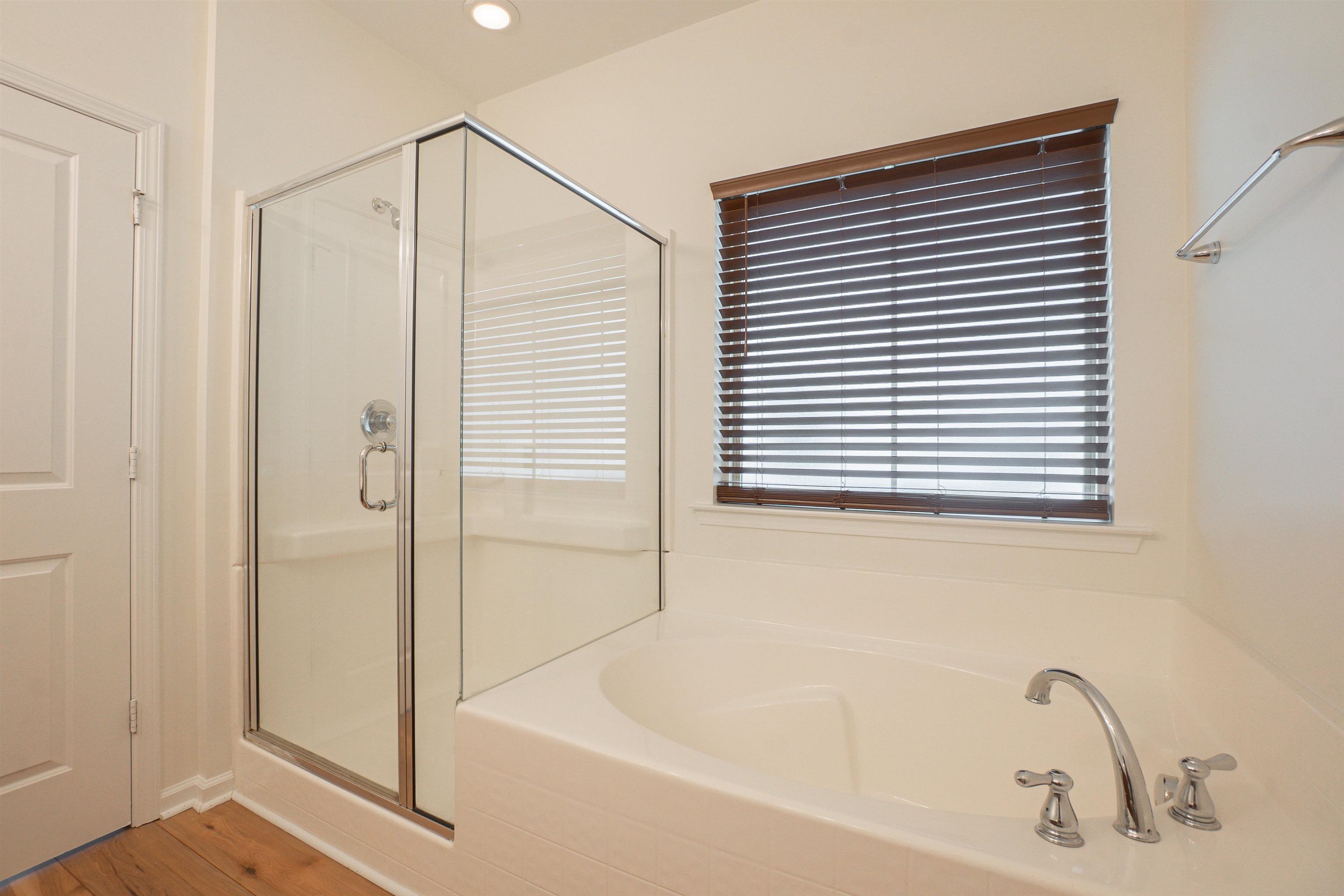 1752 Musket Trail Sumter, SC 29150 - Photo 16 of 37 Bathroom featuring a stall shower, a garden tub, recessed lighting, and wood finished floors