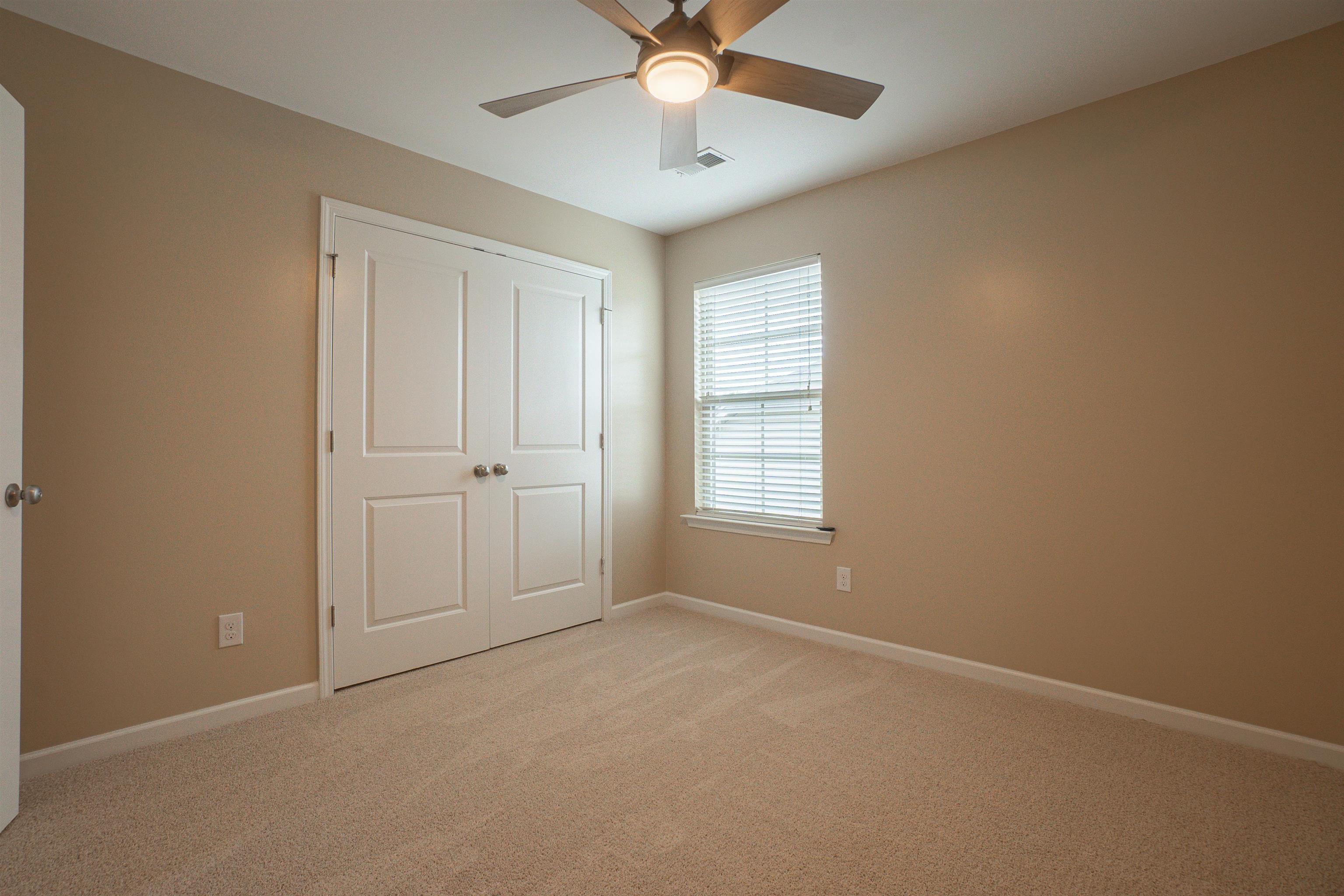 1752 Musket Trail Sumter, SC 29150 - Photo 27 of 37 Unfurnished bedroom featuring light colored carpet, ceiling fan, and a closet