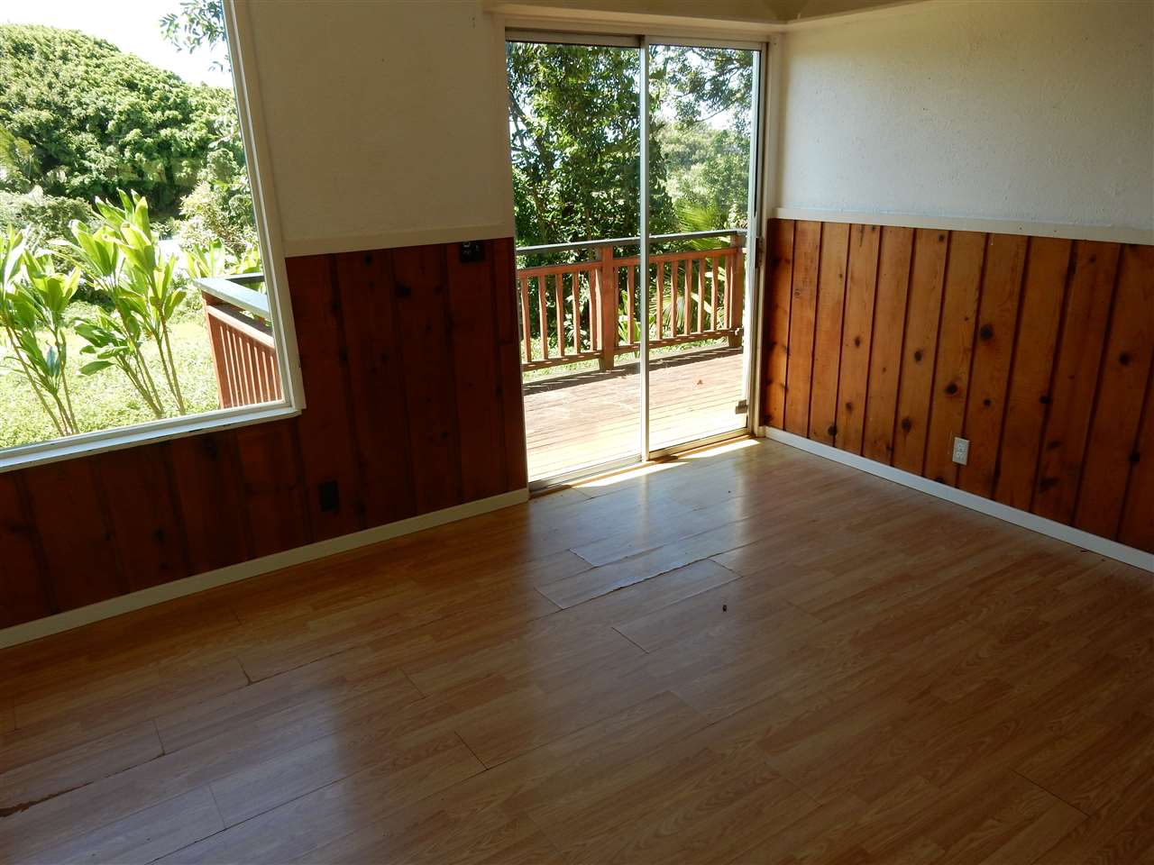 1661 West Kuiaha Road Haiku, HI 96708 - Photo 10 of 16 an empty room with wooden floor and windows