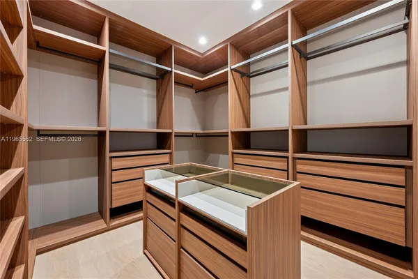 a bathroom with a large tub sink and large mirror
