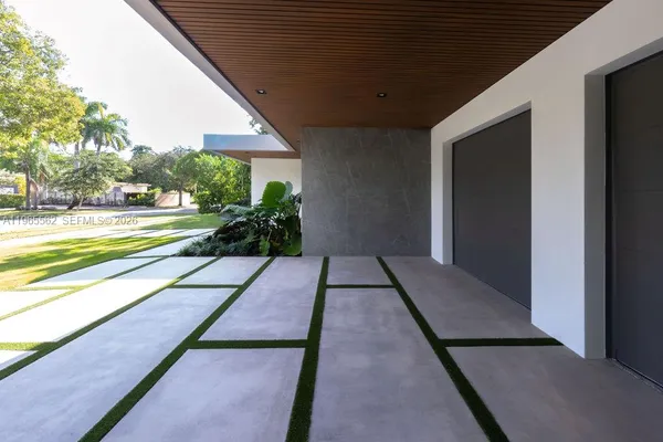 a view of a door of the house and trees