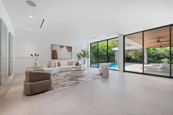 a living room with furniture and large windows