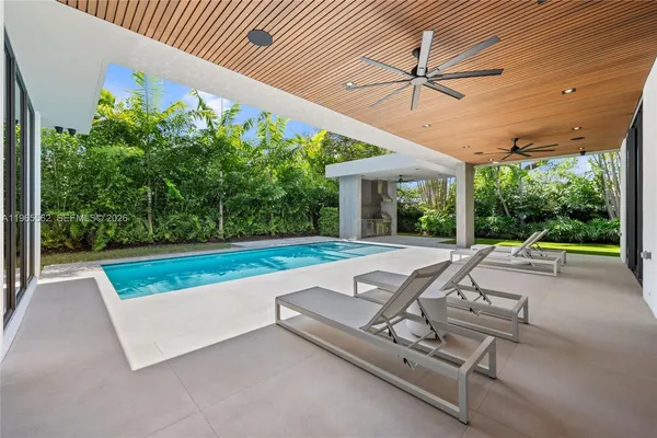 a view of swimming pool with a patio