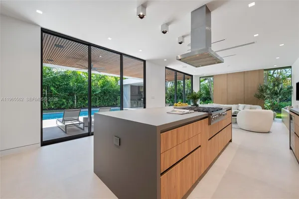 a large kitchen with a large window and stainless steel appliances