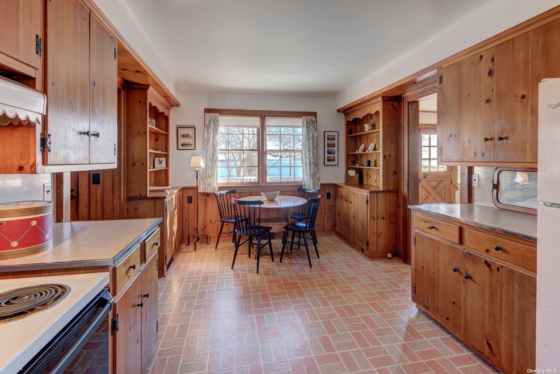 199 Old Harbor Road New Suffolk, NY 11956 - Photo 11 of 15 a view of a dining room with furniture and chandelier
