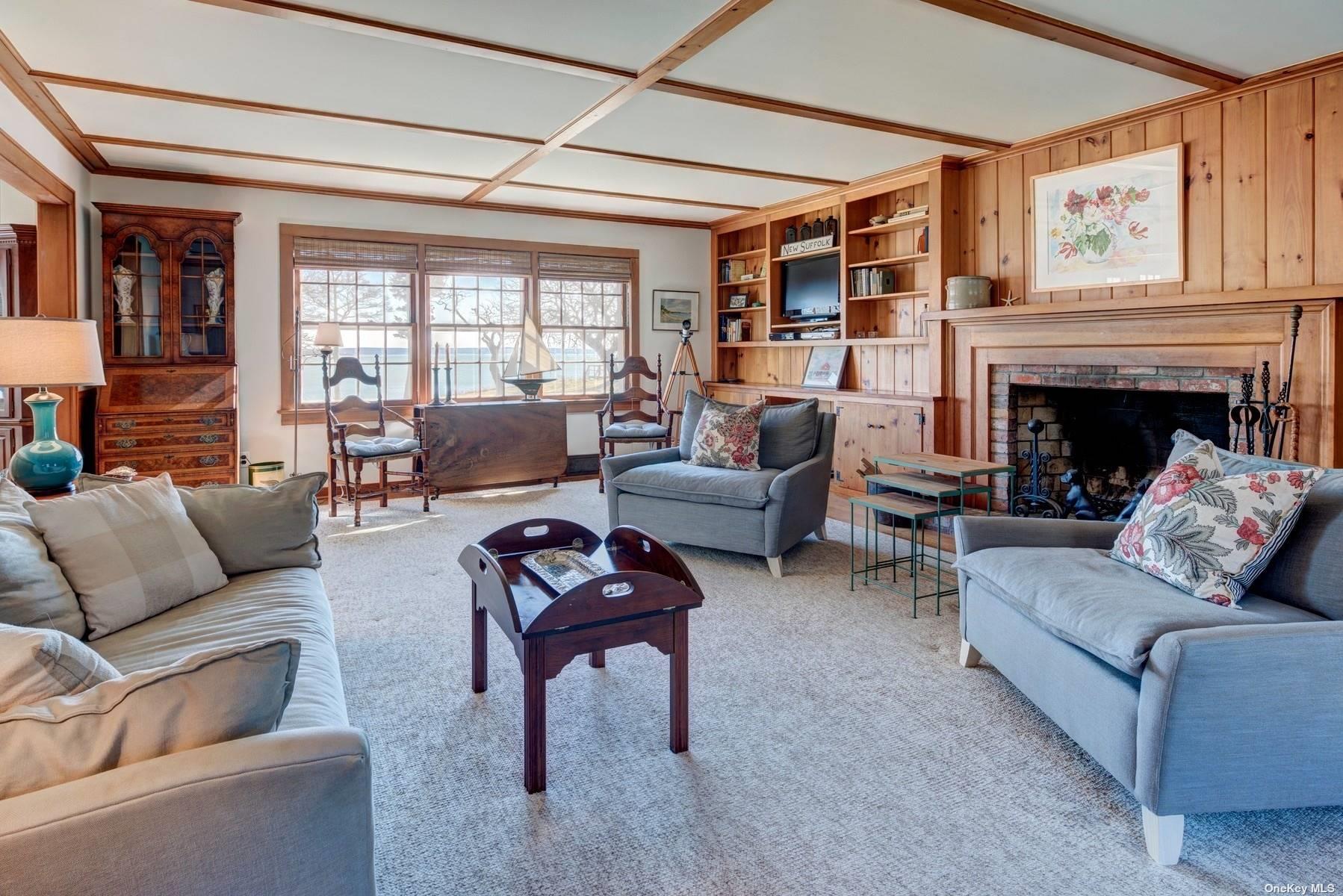 199 Old Harbor Road New Suffolk, NY 11956 - Photo 9 of 15 a living room with furniture and a fireplace